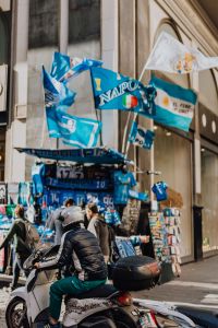 Stall with gadgets for fans of the football club SSC Napoli, blue flags and T-shirts