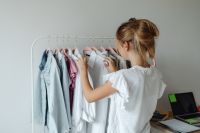 Kaboompics - A teenager picks clothes from a hanger in her room