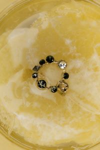 Kaboompics - Gold Ring with Black Gemstones in Citrus Water