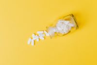 Kaboompics - White pills in yellow bottle