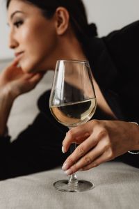 Kaboompics - Sophisticated Wine Tasting Portraits - Modern Asian Woman in Elegant Black Outfit Holding White Wine Glass