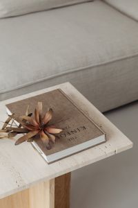 The book lies on a travertine table - Kinfolk - dried flower