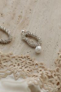 Kaboompics - Satin light beige bra trimmed with lace - silver earrings with zircons and pearls