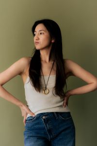 Kaboompics - Woman in Tank Top and Jeans Wearing Long Necklace