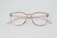 Kaboompics - Rose-Tinted Eyeglasses on a Pale Gray Surface with Minimalist Copy Space