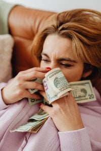 Kaboompics - Close-Up Woman Holding Dollar Bills Near Her Face