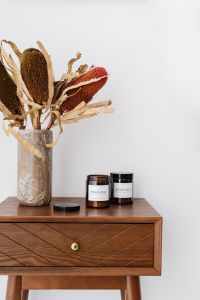 Kaboompics - Two Soy Candle Jars with Dried Protea for Neutral Home Fragrance Product Styling