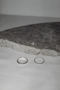 Kaboompics - Silver Rings on Dark Stone Slab and White Fabric – Fujifilm X100VI