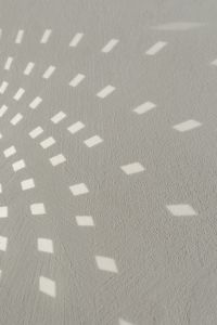 Kaboompics - Abstract White Wall with Repeating Geometric Light Patterns