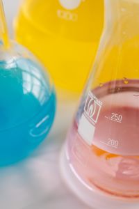 Kaboompics - Colorful Laboratory Flasks Against a Yellow Background