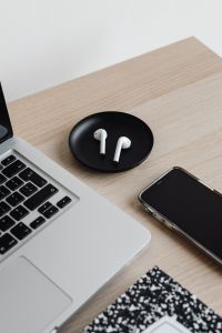 Kaboompics - Laptop, AirPods and Smartphone with Notes Notebook on Desk