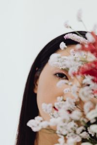 Kaboompics - Vertical Asian Portrait Partly Obscured by White and Pink Flowers