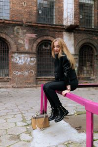 Kaboompics - Wide Fashion Portrait on a Fuchsia Courtyard Rail with Beige Handbag