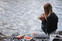 Kaboompics - Blonde woman having a healthy snack at the wooden pier