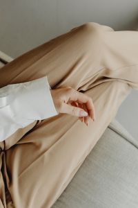 Kaboompics - Woman in Beige Trousers Sitting on Sofa