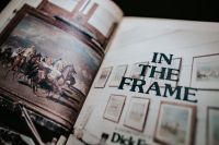 Kaboompics - Open Vintage Book Showing Framed Artwork and Typography