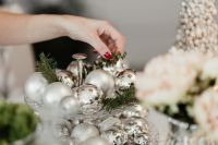 Kaboompics - Woman Arranging Silver Ornaments on a Christmas Table