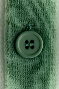 Kaboompics - Mint green knit button macro, four-hole sewing detail