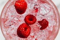Kaboompics - Four Raspberries In Ice Top View