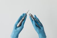 Kaboompics - Root Elevator and Extraction Forceps in Blue Gloved Hands