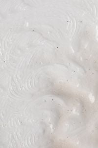 Kaboompics - White Skincare Cream Macro with Fine Dark Specks and Swirled Texture