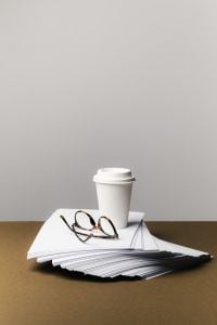 Kaboompics - Paper Stack With Coffee Cup And Glasses Minimal Workspace