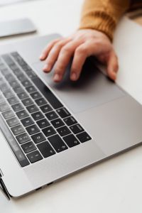 Kaboompics - Man works on a computer at his desk, mobile phone