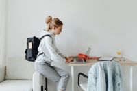 Kaboompics - Teenager Studying on Laptop with Backpack at Home