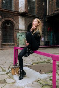 Kaboompics - Relaxed Side-View Streetwear Portrait on a Pink Metal Rail at a Brick Factory