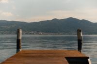 Kaboompics - Wooden Jetty Facing the Mountains Across Lake Iseo