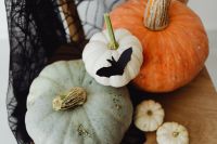 Kaboompics - Orange and White Pumpkins with Bat Decorations on Spiderweb Chair