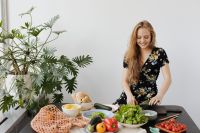Kaboompics - Smiling Woman Chopping Avocado for a Fresh Salad in a Bright Home Kitchen