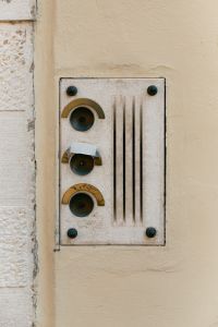 Kaboompics - Vintage Three-Button Doorbell on Cream Plaster Wall, Italy