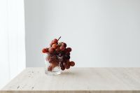 Kaboompics - Red Grapes in a Cut Glass on Travertine with Copy Space