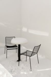 Kaboompics - Snow-Covered Patio with Black Wire Chairs and Table