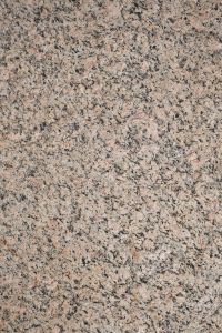 Kaboompics - Pale Pink and Gray Granite-Like Rock with Dense Black Mineral Speckles, Stone Surface Background