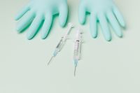 Kaboompics - Two Nitrile Gloves with Syringes in a Wide Medical Flat Lay