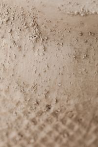 Kaboompics - Rough Beige Clay-Plaster Texture with Small Raised Lumps and Grain