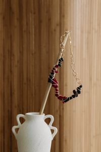 Kaboompics - Red and Black Beaded Necklace on a Ceramic Vase