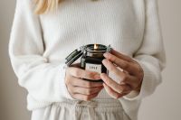 Kaboompics - Woman Holding a Love Candle in Neutral Knitwear