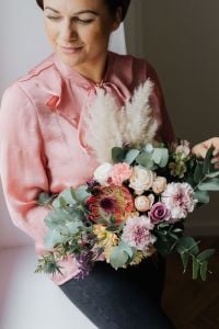 Kaboompics - Woman in Pink Blouse Posing with a Paper-Wrapped Bouquet