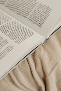 Kaboompics - Close-Up of an Open Book on a Beige Knit Blanket