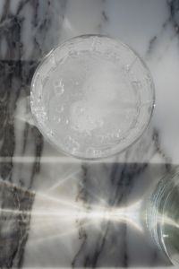 Kaboompics - Close-Up of an Empty Glass on Gray Marble with Sunlight