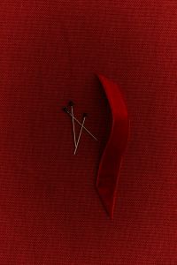 Kaboompics - Burgundy Ribbon and Sewing Pins on Burgundy Fabric