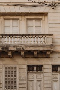 Kaboompics - Maltese Building Facade with Stone Balcony and Shuttered Windows