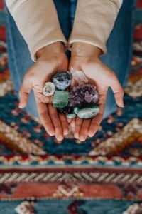 Kaboompics - Cupped Hands Holding Assorted Healing Crystals in a Neutral Spiritual Lifestyle Photo