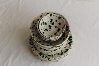 Kaboompics - Top-Down Stack of Green Splatter Bowls and Plates