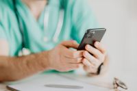 Kaboompics - Close-Up of Doctor Using Smartphone