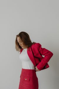 Kaboompics - Woman Adjusting a Pink Skirt Suit