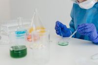 Kaboompics - Gloved Scientist Pipetting a Sample Into a Petri Dish